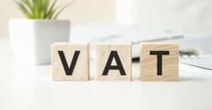 Vat,On,Wooden,Cubes,Over,Blur,Background,With,Copy,Spcae,